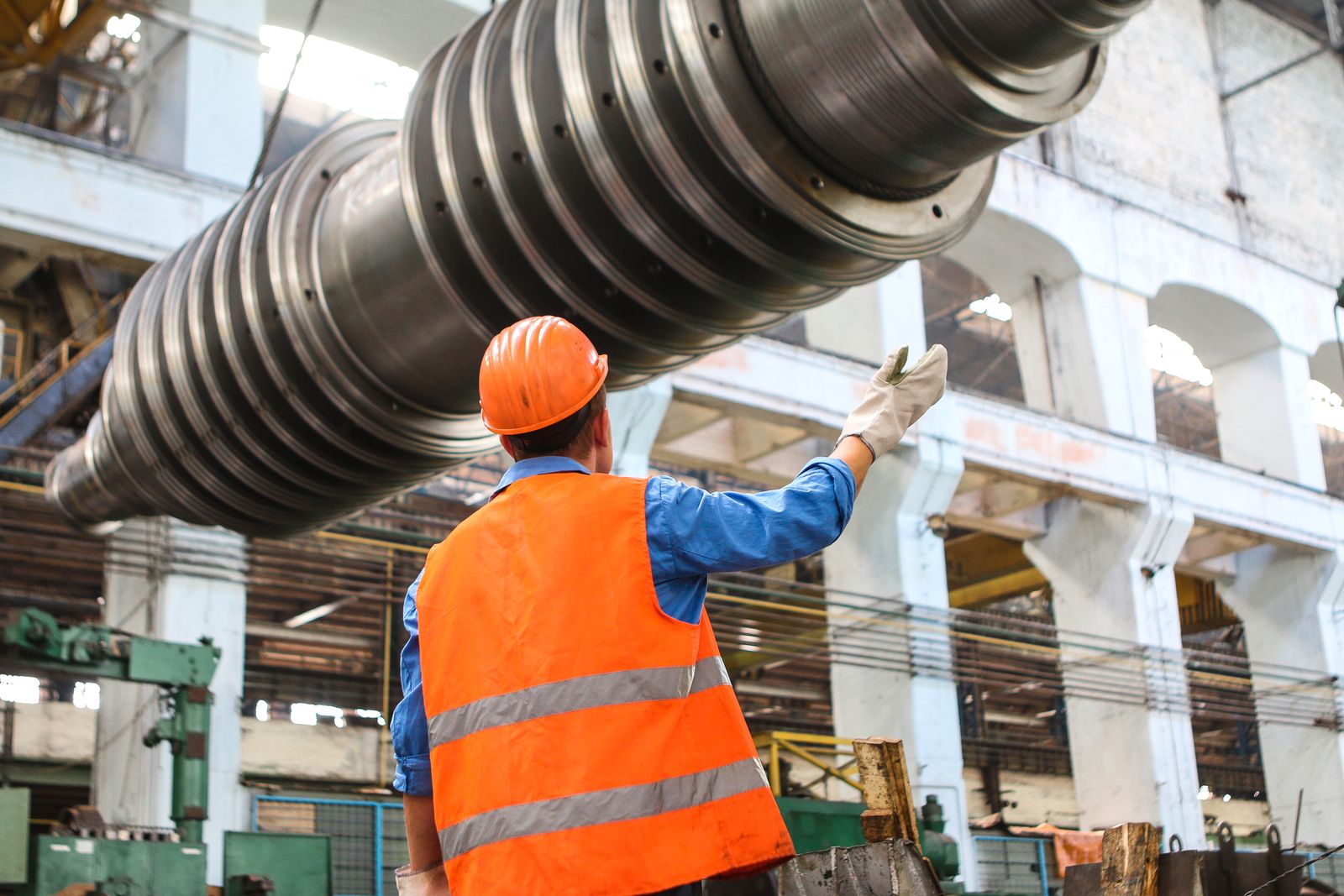 Worker handling industrial pipe at a supply facility